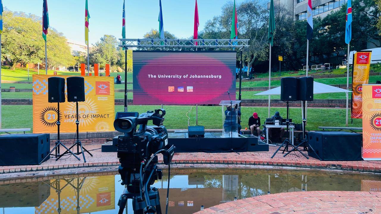 Campus activation stage with LED screen and broadcast camera