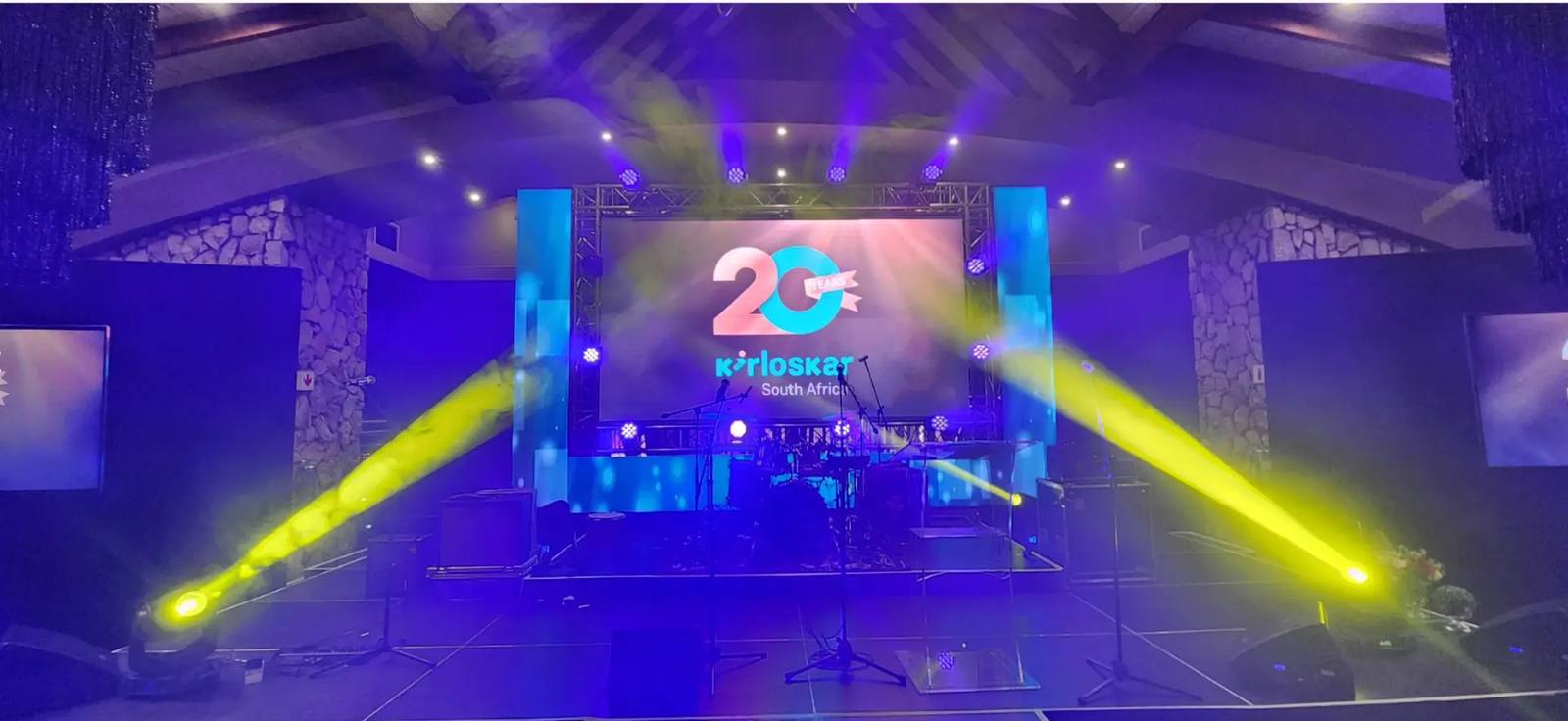 Live band stage with beam lighting and LED screen